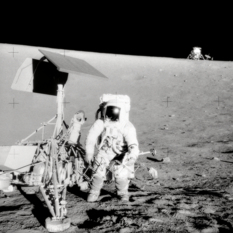Pete Conrad at the Surveyor 3 spacecraft, with the Apollo 12 Lunar Module in the background