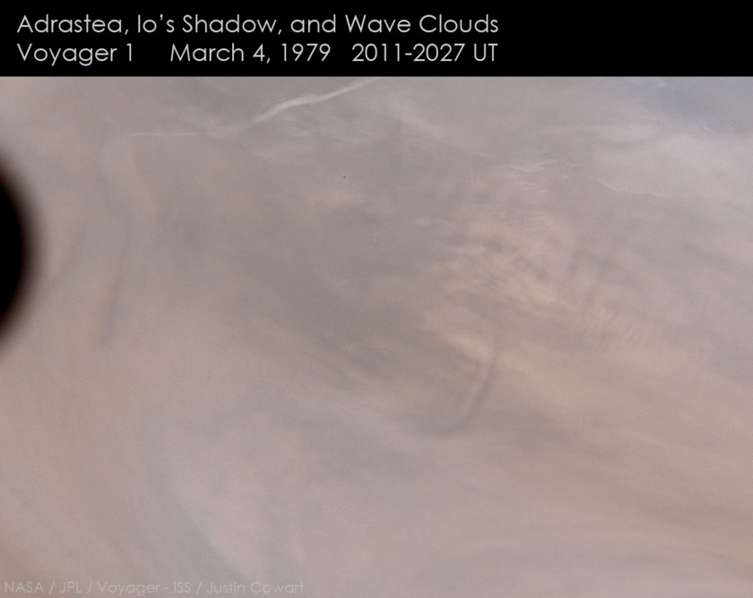 Adrastea, Io's shadow, and wave clouds on Jupiter