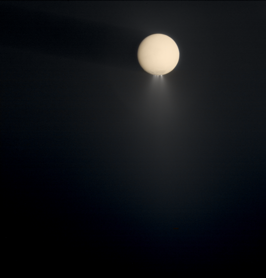 Enceladus at high phase, casting a shadow onto the E ring