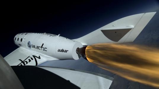 View from SpaceShipTwo of its rocket firing