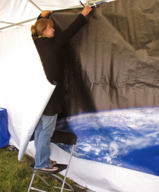 A gust of wind wraps a banner around Monica Lopez