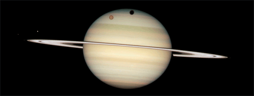 Hubble catches four moons on the face of Saturn