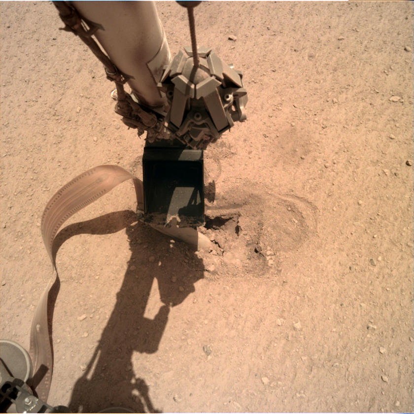 InSight presses its robotic arm on the mole