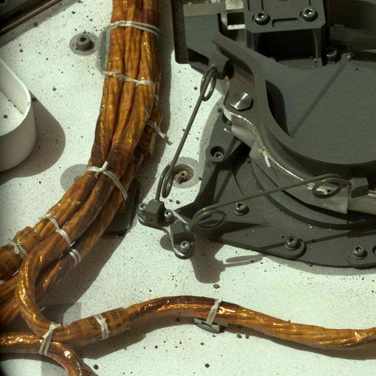 Spot ties affixing cable bundles to tie-down points