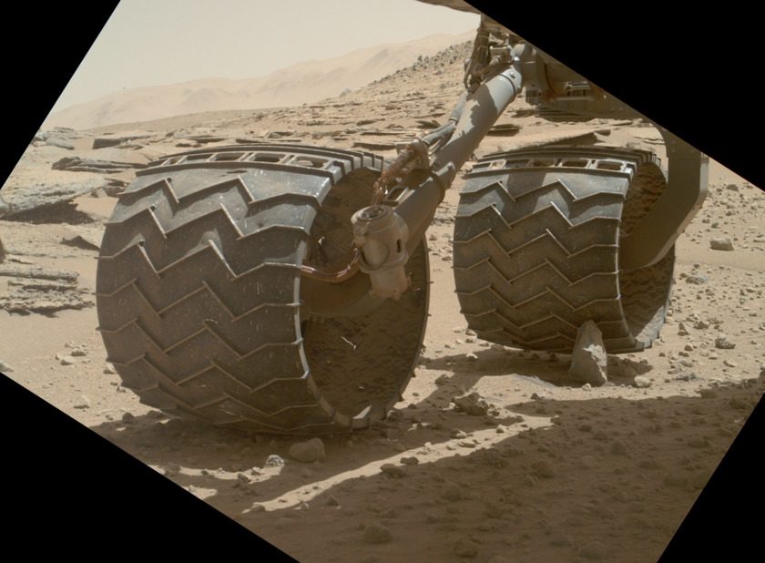 Curiosity wheel perched on a rock, sol 631