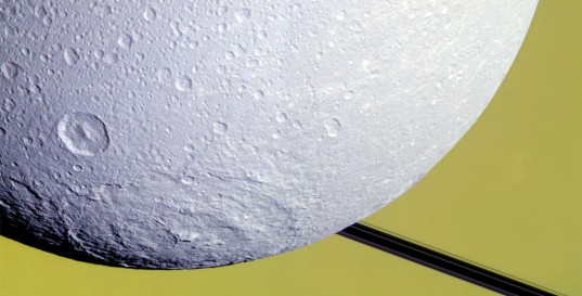 Dione's Evander basin caught against Saturn and rings