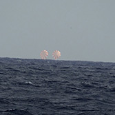 Dragon splashes down