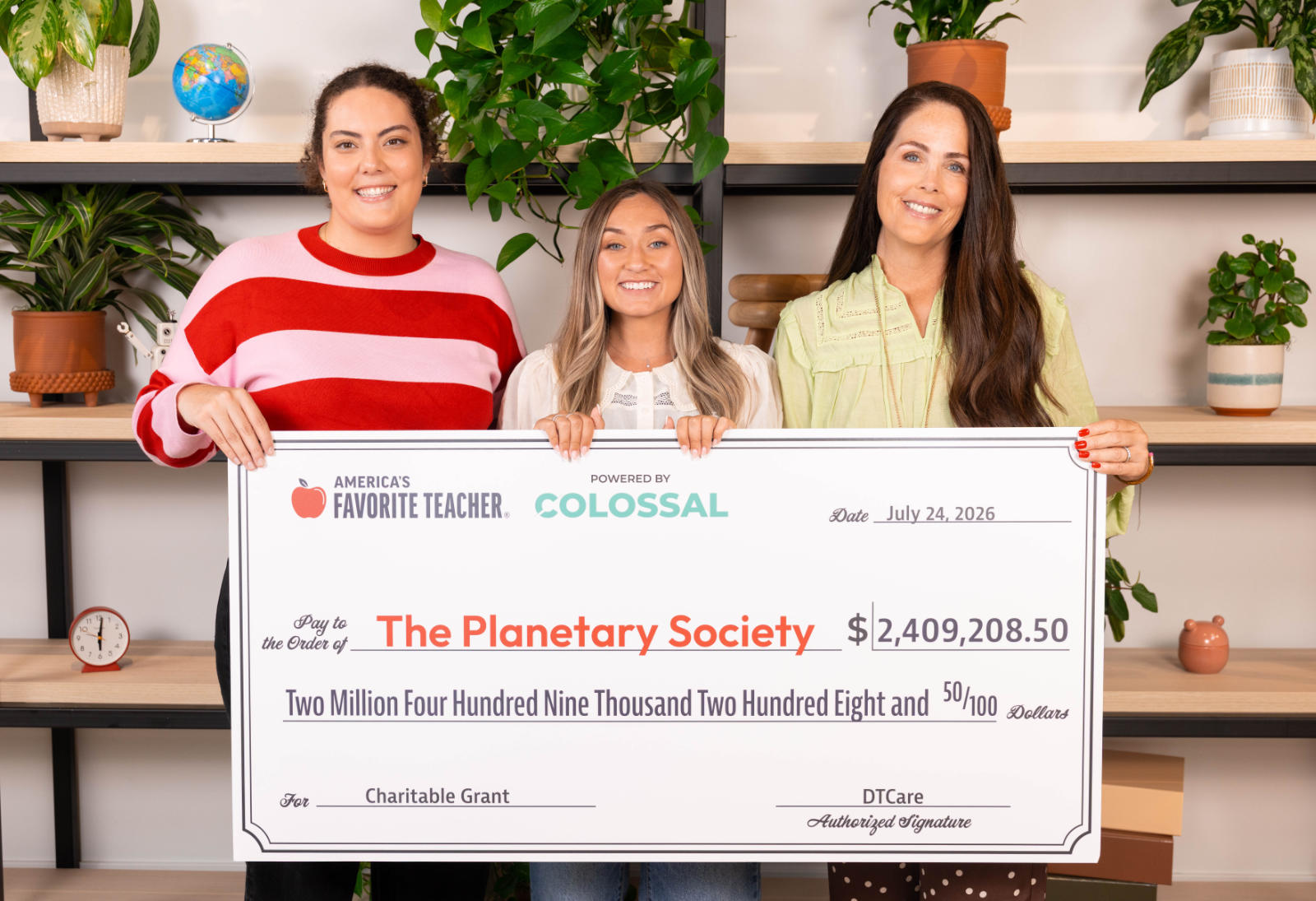 Teachers holding check from Colossal campaign