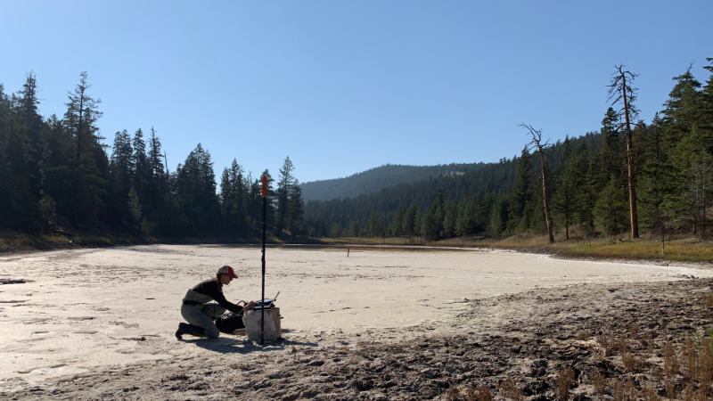 Person sampling a saline lake