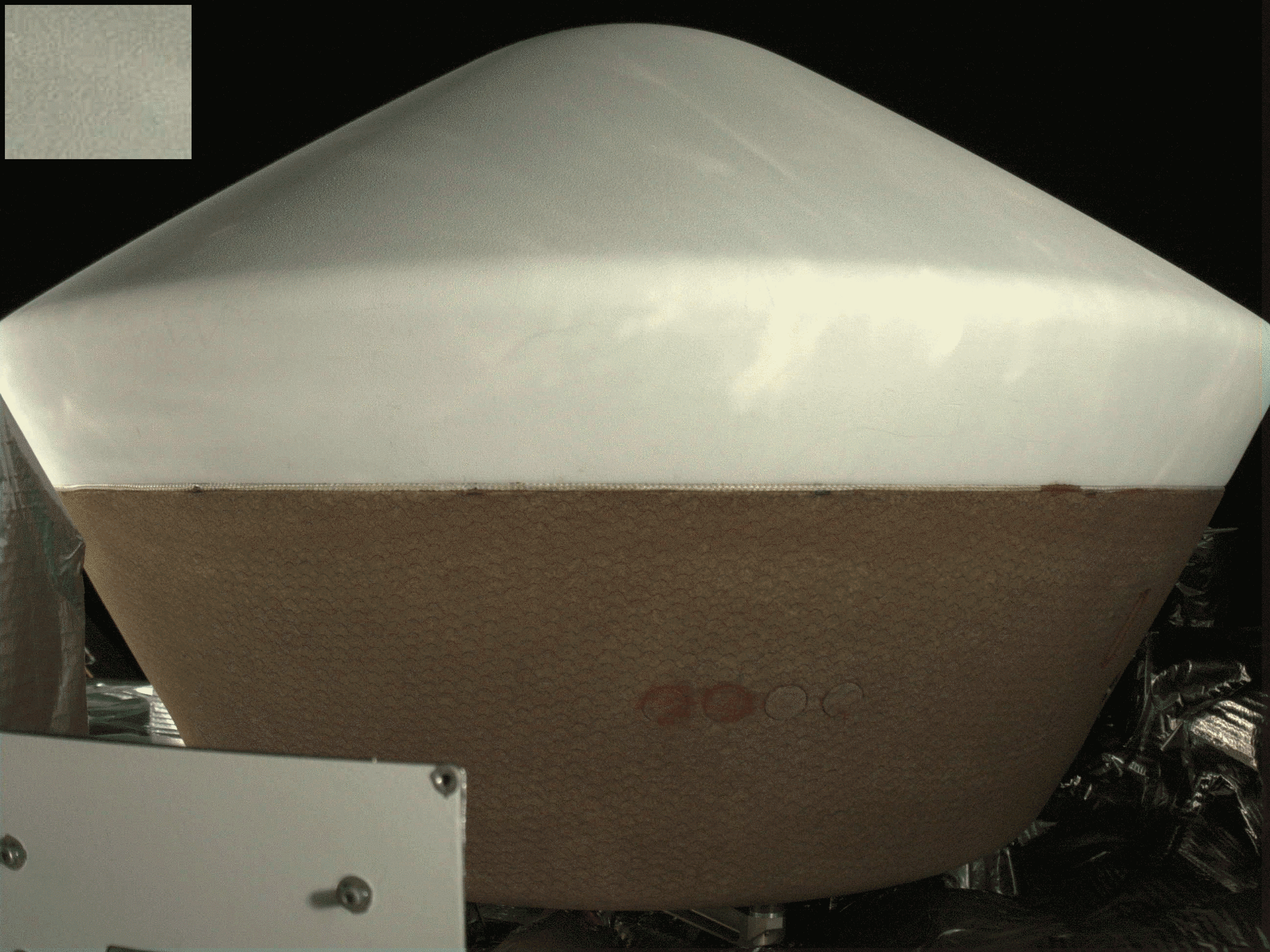 Teeny impact on the OSIRIS-REx sample return capsule heat shield
