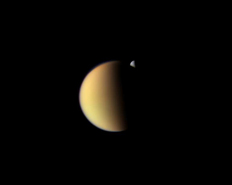 Rhea behind Titan | The Planetary Society