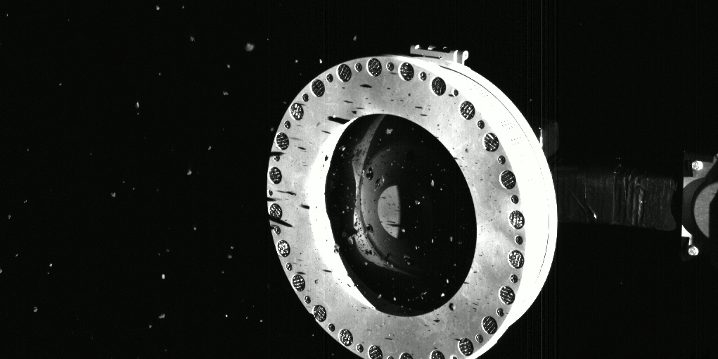 Bits of Bennu Float from OSIRIS-REx's Sample Head